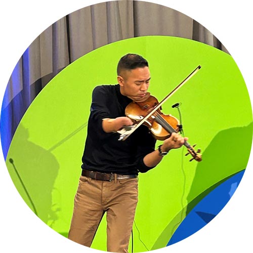 An adult standing and playing violin