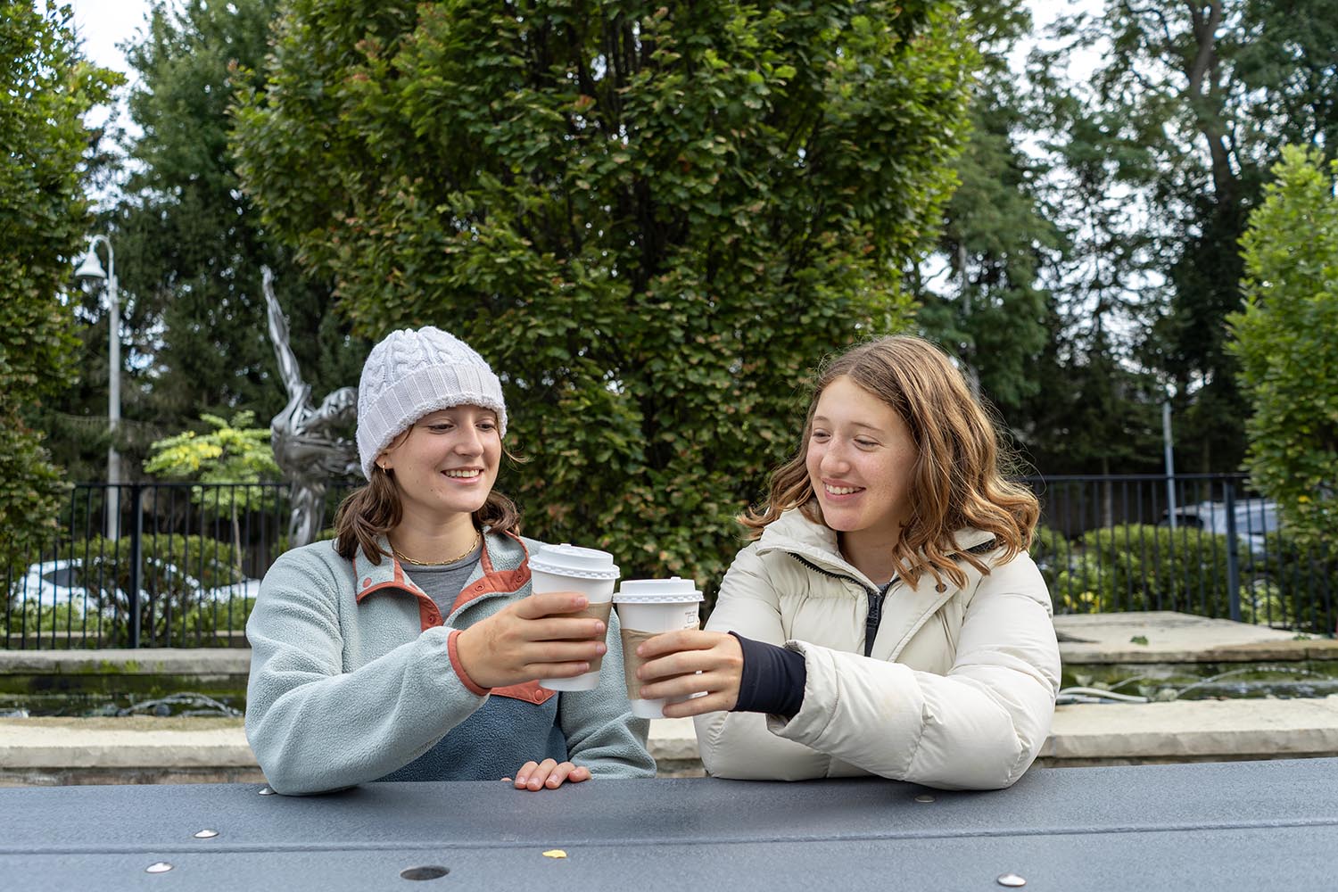 Amira [left] shares a moment with her sister Aaliyah, in the hospital’s front courtyard. The teen recently shared her autism journey as part of an empowering video series featuring autistic youth talking about their experiences, including assessments.