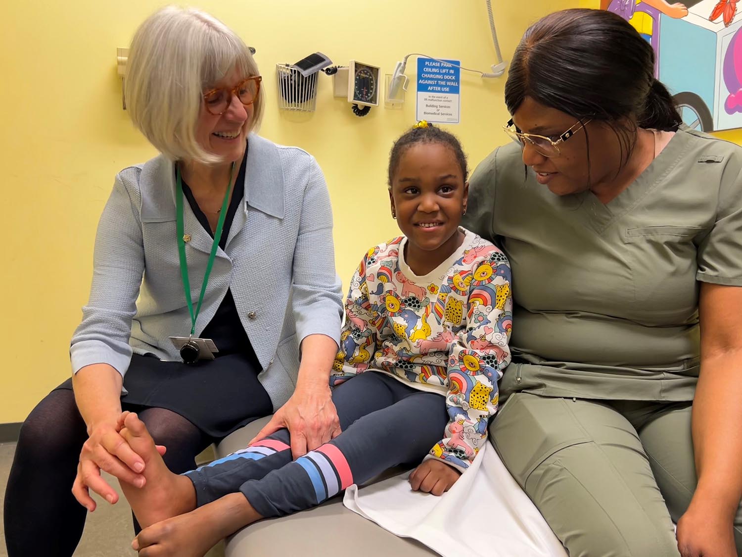 Dr. Fehlings assesses a client, Kionna, in the hypertonia clinic with the child’s mom, Racquel, by her side.