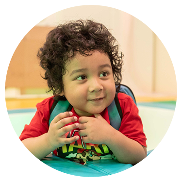 A child holding a toy with smile