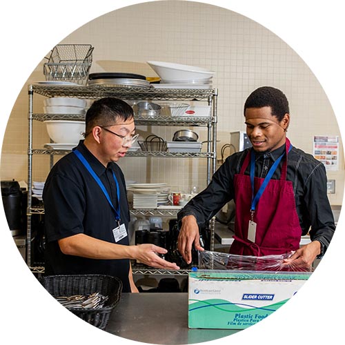 Two kitchen staffs at work