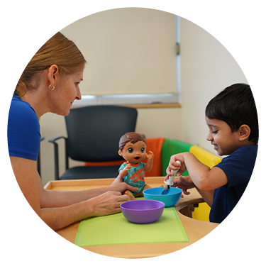 An adult playing toys with a kid